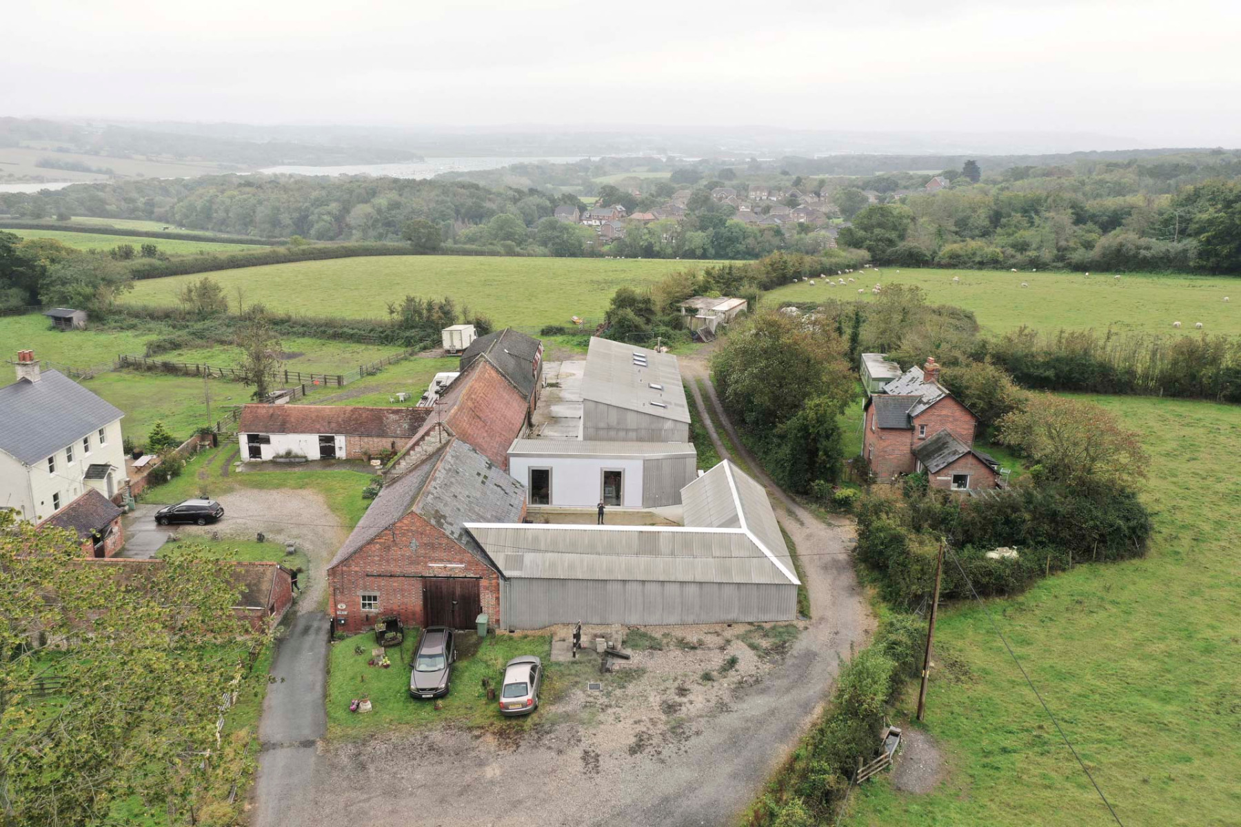 The two refurbished buildings are easily recognised by their corrugated fibre cement cladding. In the background is another owner's building, which was refurbished by a different architect using the same range of materials. © James Eagle